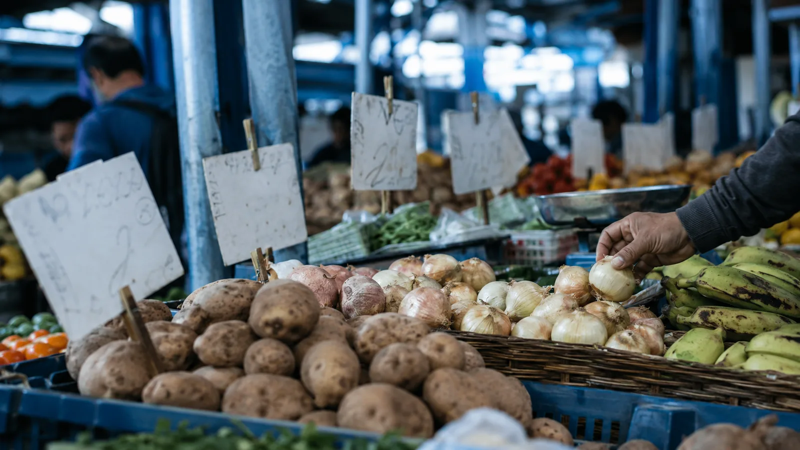 Puesto de plaza de mercado con etiquetas de precios, imagen del encarecimiento de la canasta familiar por la inflación.